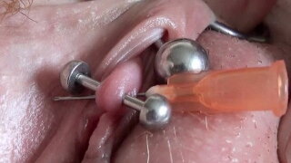 Real Clitoris piercing and through with a needle 